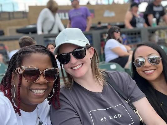 Trish shown with a friend at a sporting event.