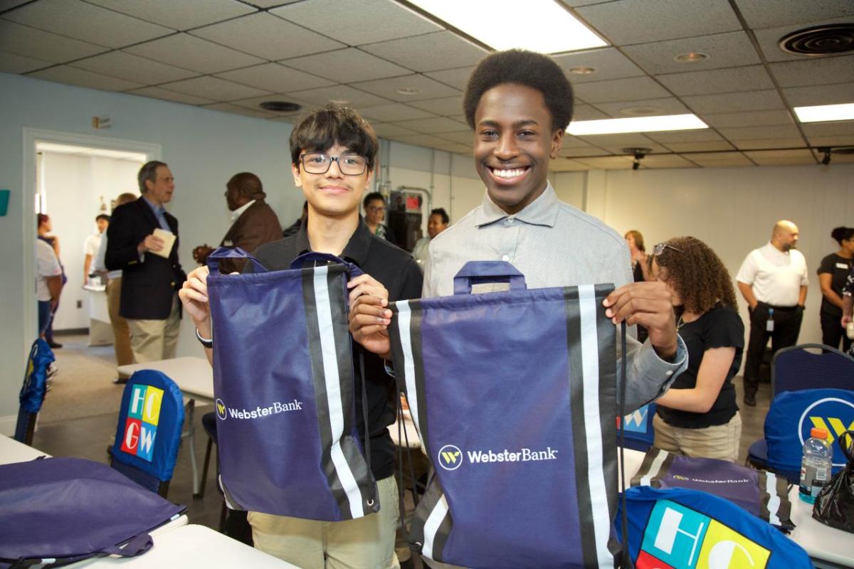 two students holding Webster Bank bags