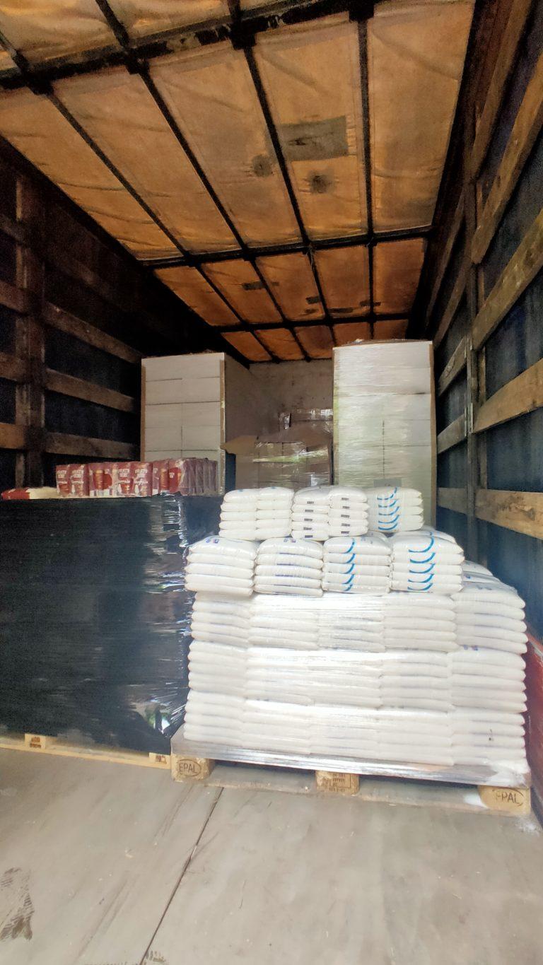 inside a trailer, pallets of wrapped supplies, food, etc.