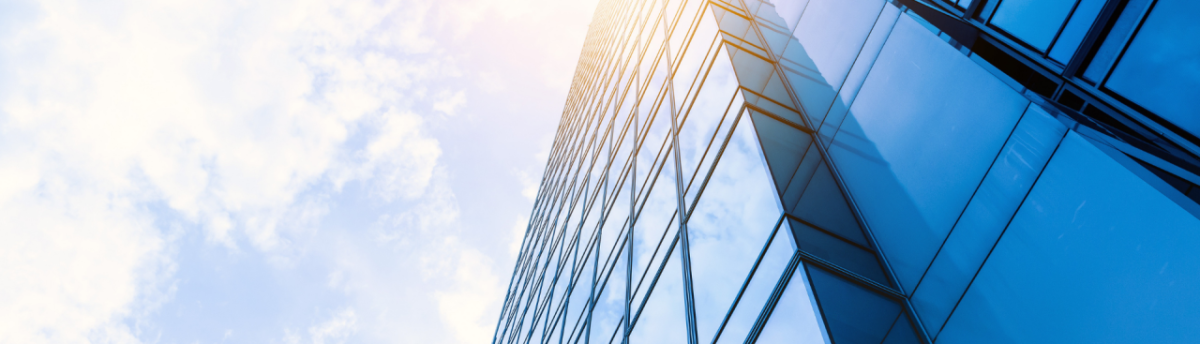 tall, glass building and sky overhead