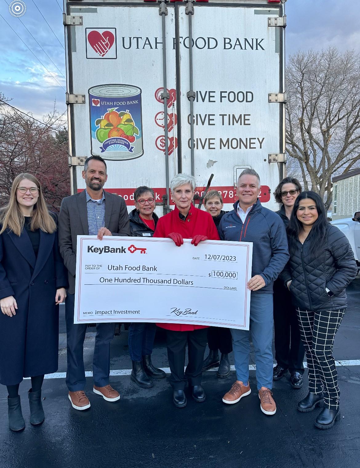 Representatives from KeyBank and the Utah Food Bank shown with a $100,000 grant check.