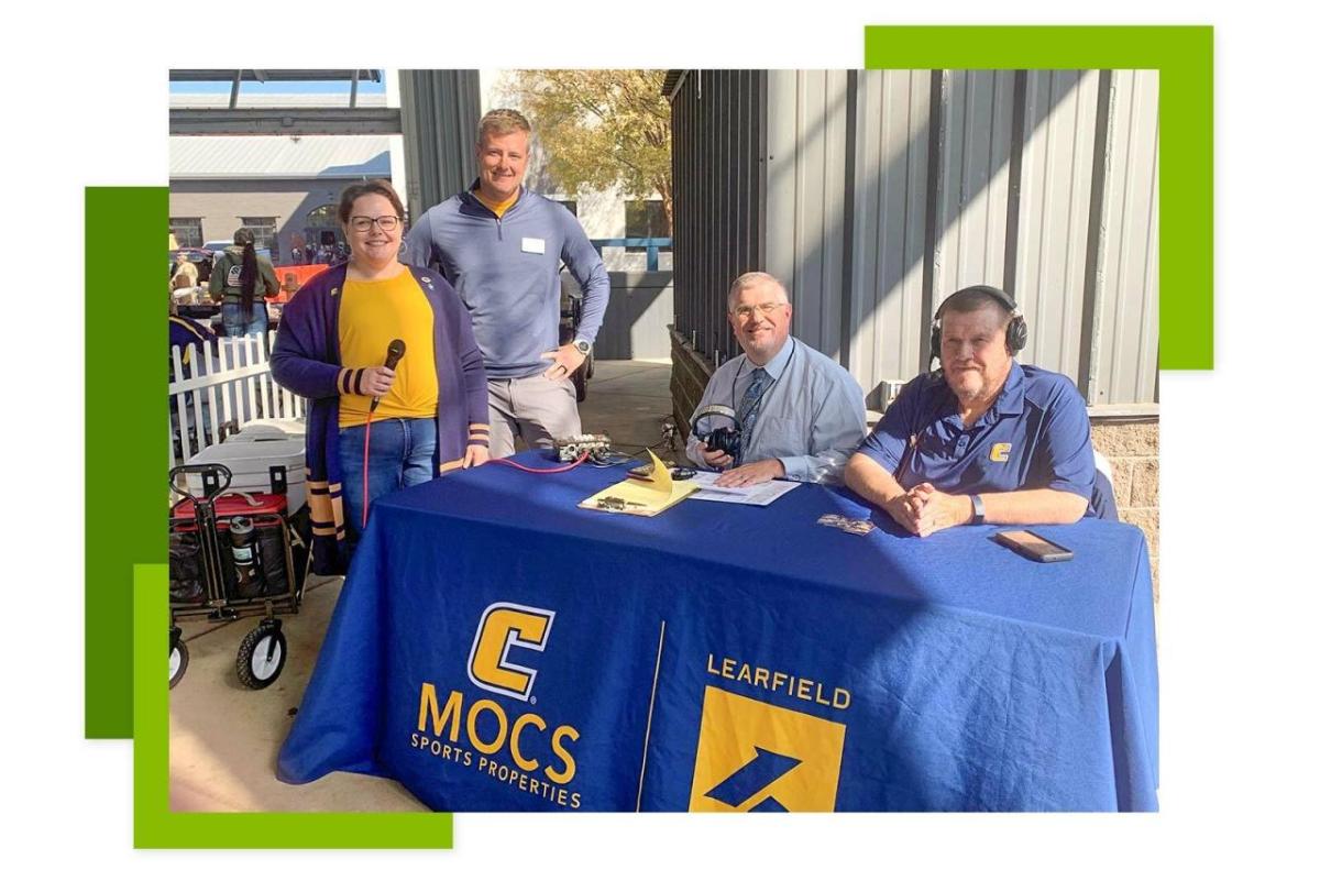 Four people stood at an event stand