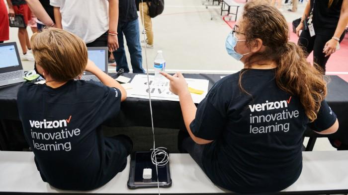 Tech team members Ashden Parker and Devyn Beat help with device distribution. Credit: Saeed Rahbaran