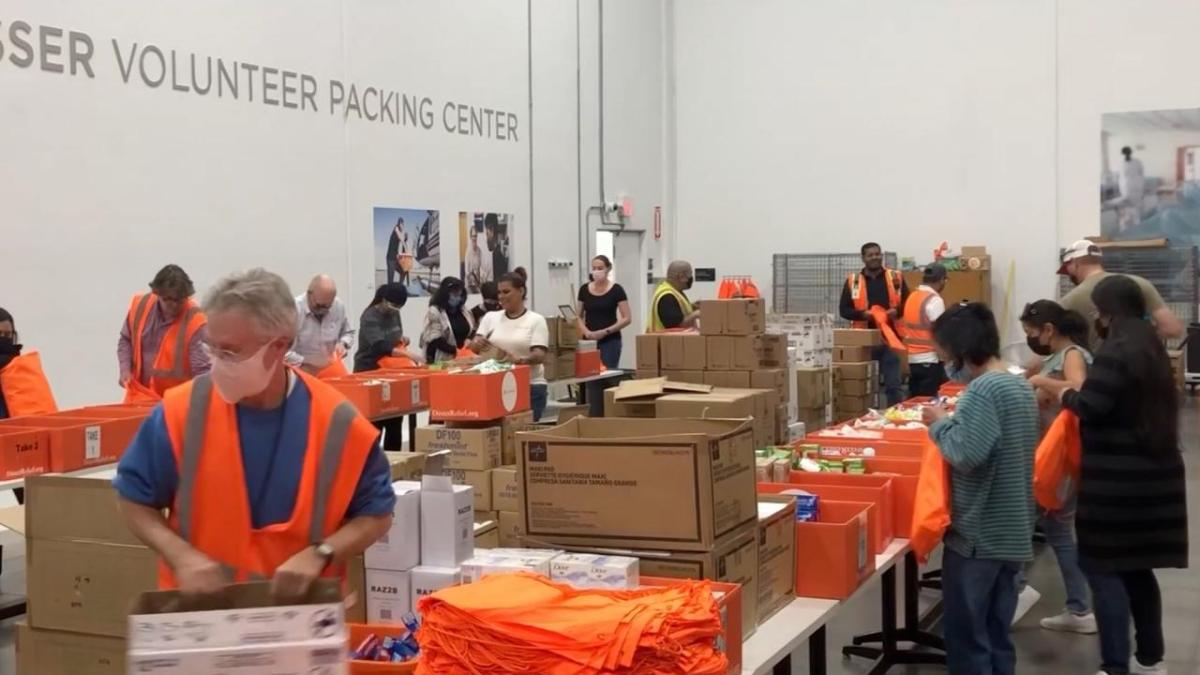 volunteers packing boxes of supplies