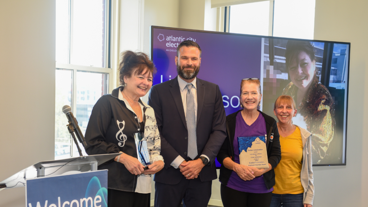 A group of people, including Linda Lamberson, receiving an award