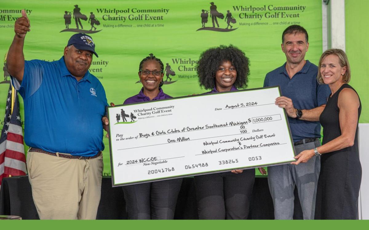 5 people holding up a big check