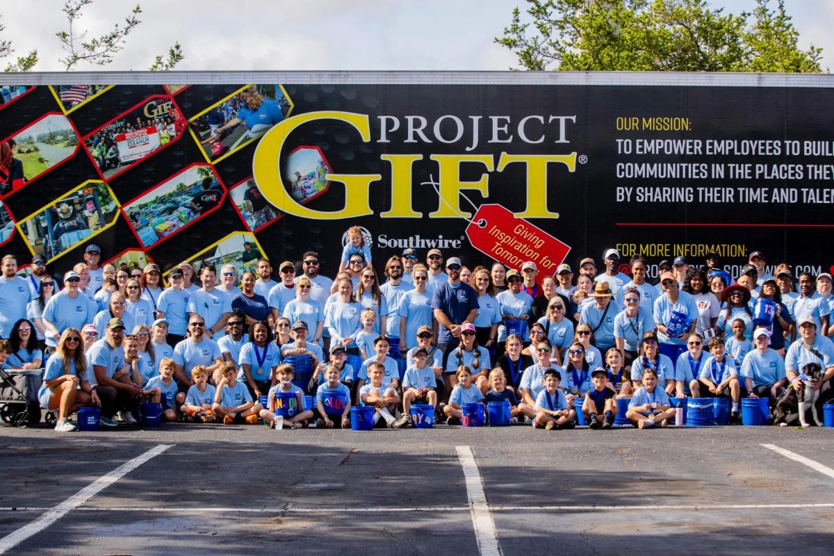 Group photo in front of Project GIFT trailer