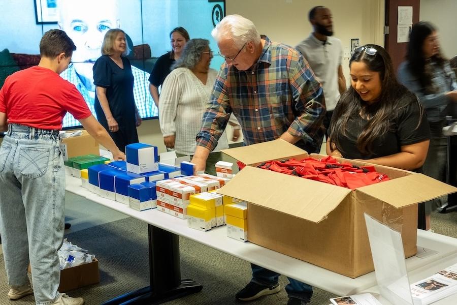 Wesco volunteers packing supplies for donations.