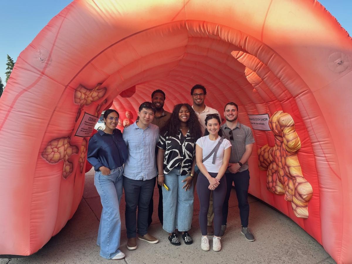 Students shown in a model of a human colon.