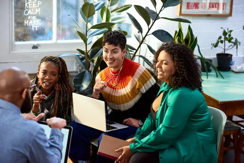 Group of four people sitting and chatting.