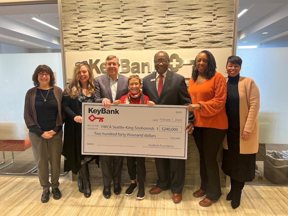 Team members from the YWCA Seattle and KeyBank shown with a $240,000 grant check.