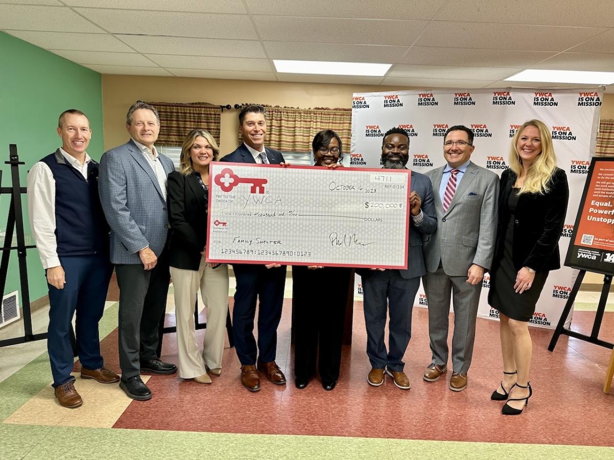 KeyBank leadership and YWCA of Rochester representatives receiving a $200,000. grant check.