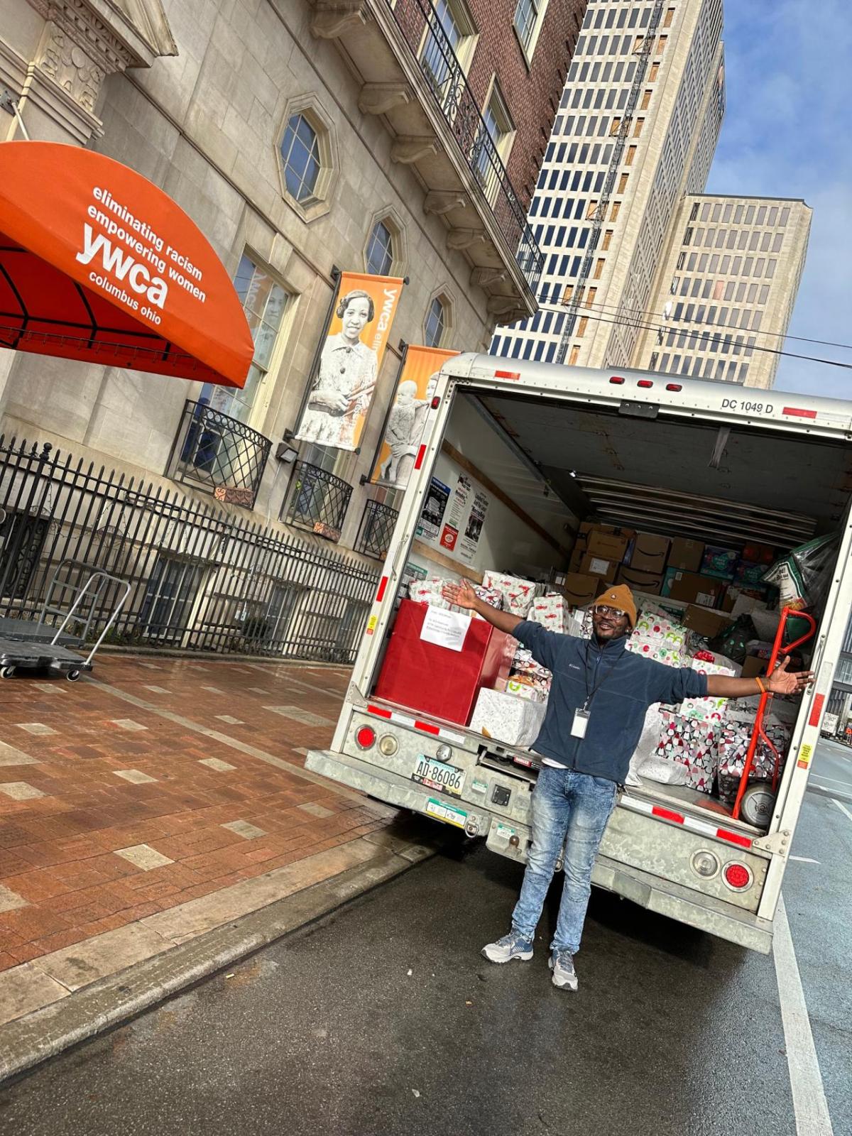 Bath & Body Works associate stands in front of a special delivery of Bath & Body Works personal care and home fragrance product donation to the YWCA’s Women’s Residency Program.