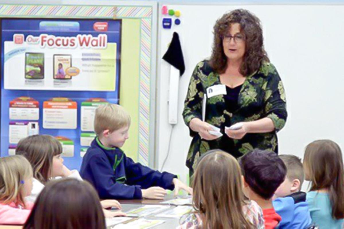 Yolanda Hollingsworth standing in front of a class of students.