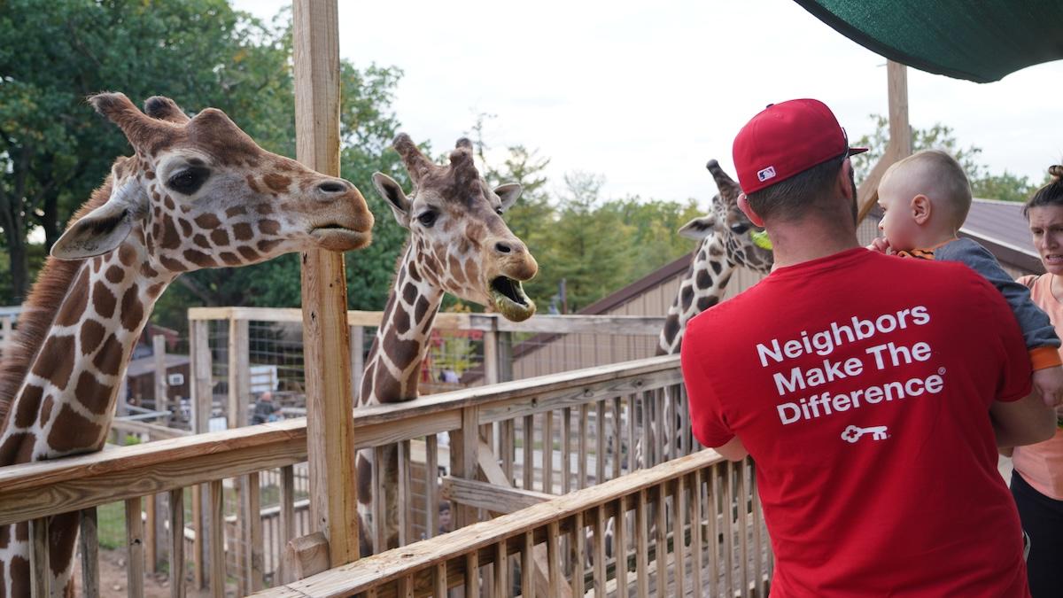 Family with an infant visiting the zoo.