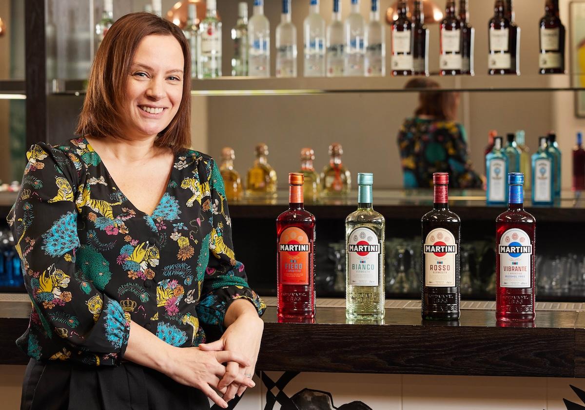 person sitting next to MARTINI bottles