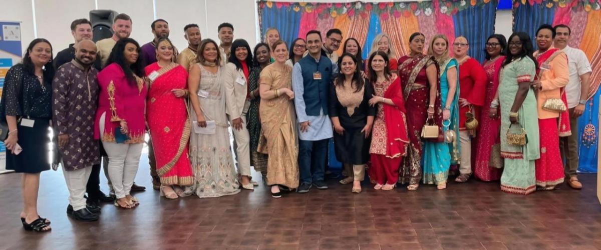 A group posed in AAPI cultural garments