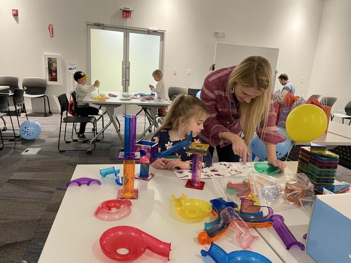 adult and child participating in science experiments and activities