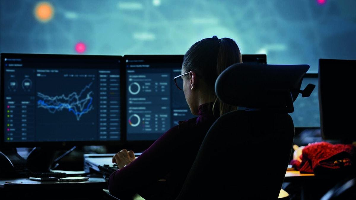 Person at bank of computer monitors