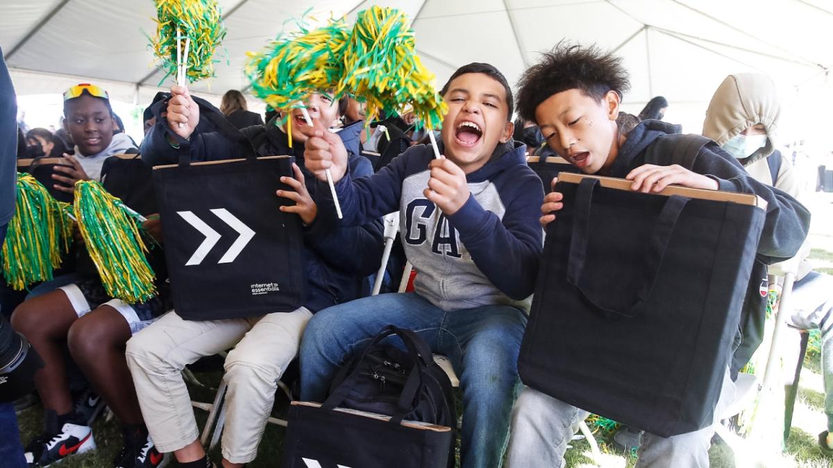 Saint Rest Baptist Church youth enthusiastically reacting to their free personal laptops during a Project UP digital equity event in Fresno. 