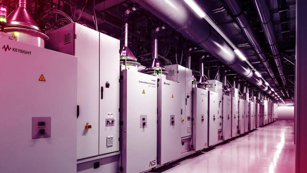 A walkway in front of closely lined energy storage containers.