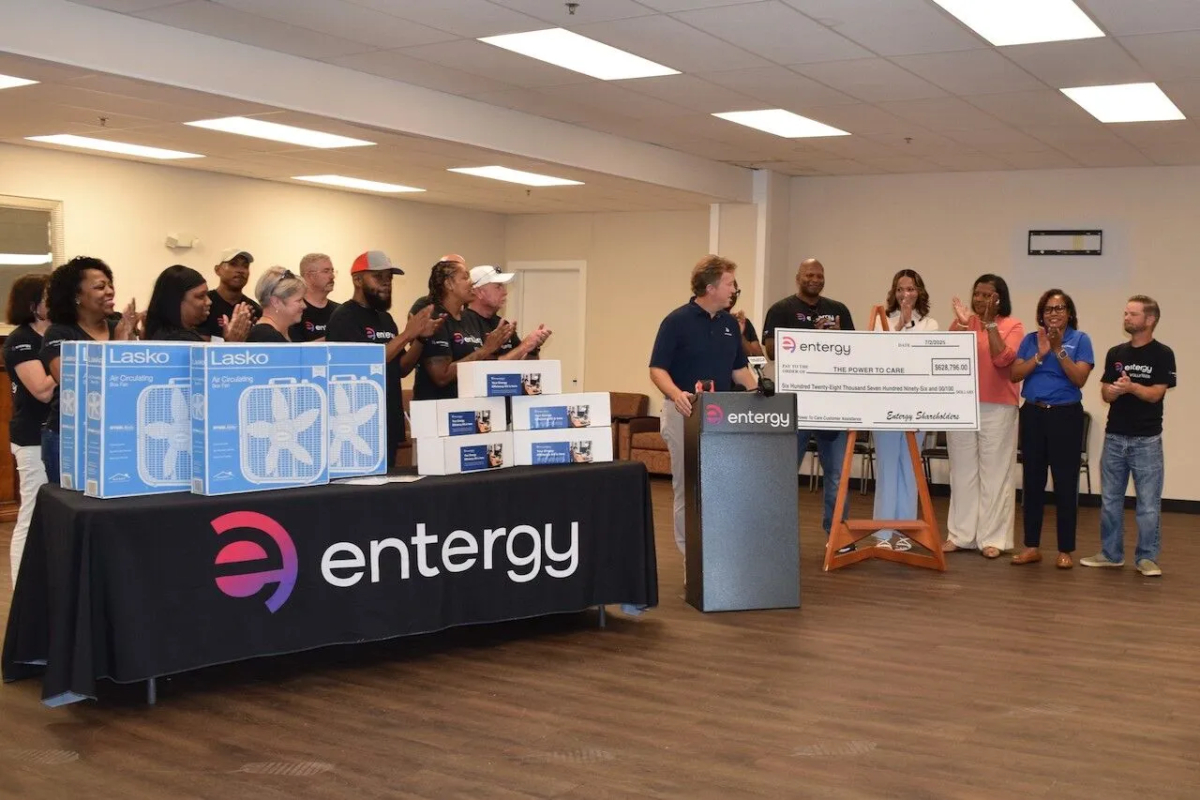 An oversized check being presented, a group clapping