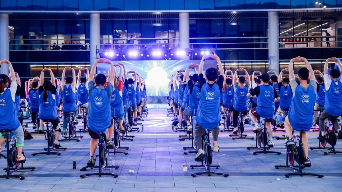 People on stationary bikes aligned.