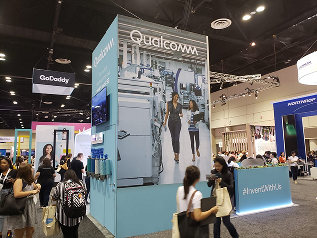 people walking around Qualcomm's booth