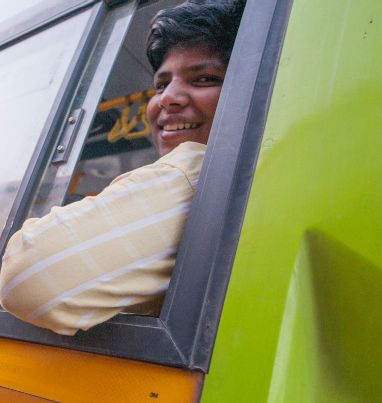 a rider leaning out of a bus window