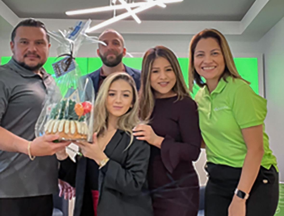 Employees holding a cake