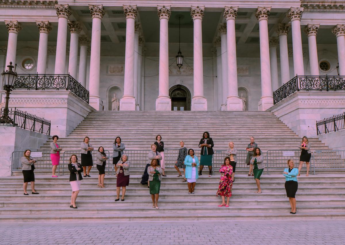 women standing on the steps of Capital Hill