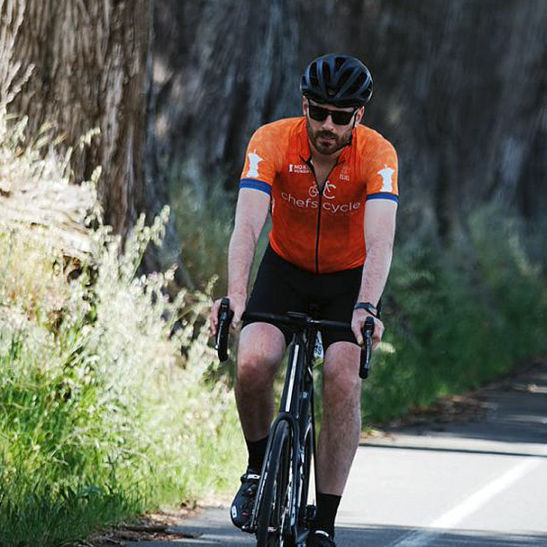 Man bicycling outdoors on a road