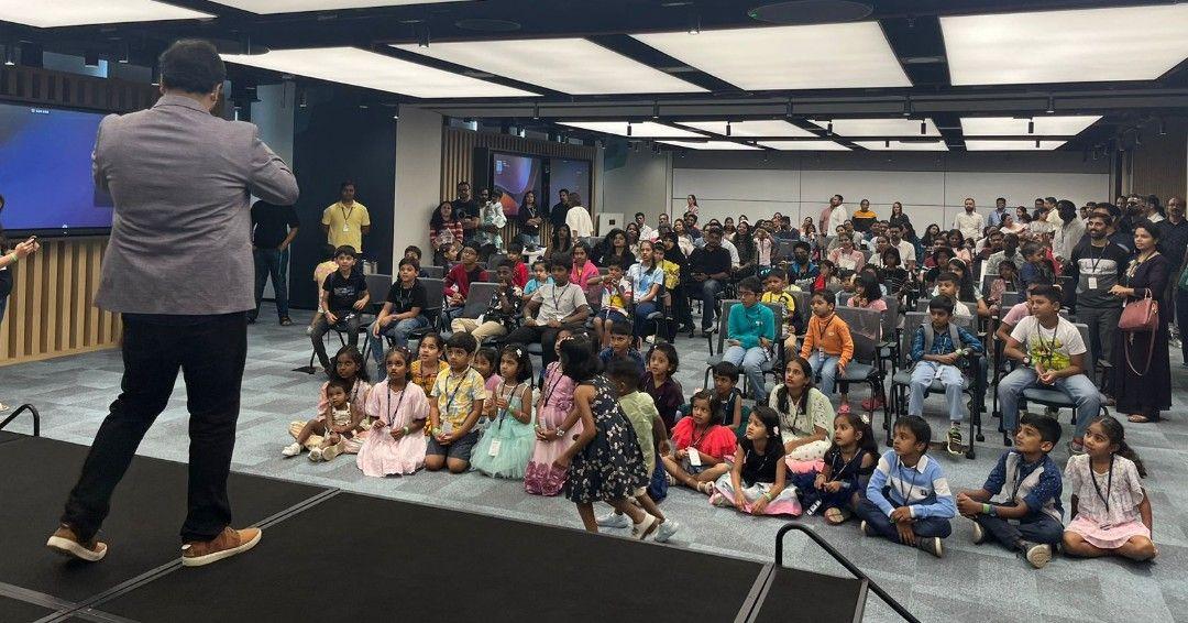 Employees and their children watching a presenter