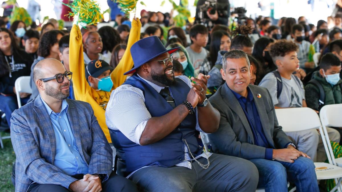 Rigo Topete, Area Vice President of Field Operations of Comcast California, DJ Criner, Pastor at Saint Rest Baptist Church, and Miguel Arias, Fresno City Council Member, at a Project UP event in Fresno with students from the community.