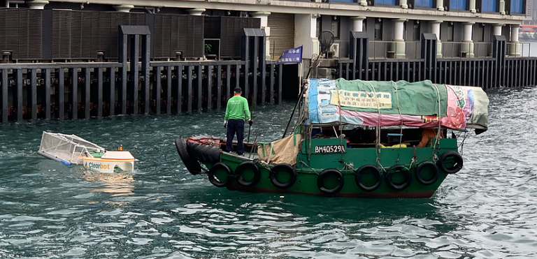 Clearbot (left) and small boat on a river