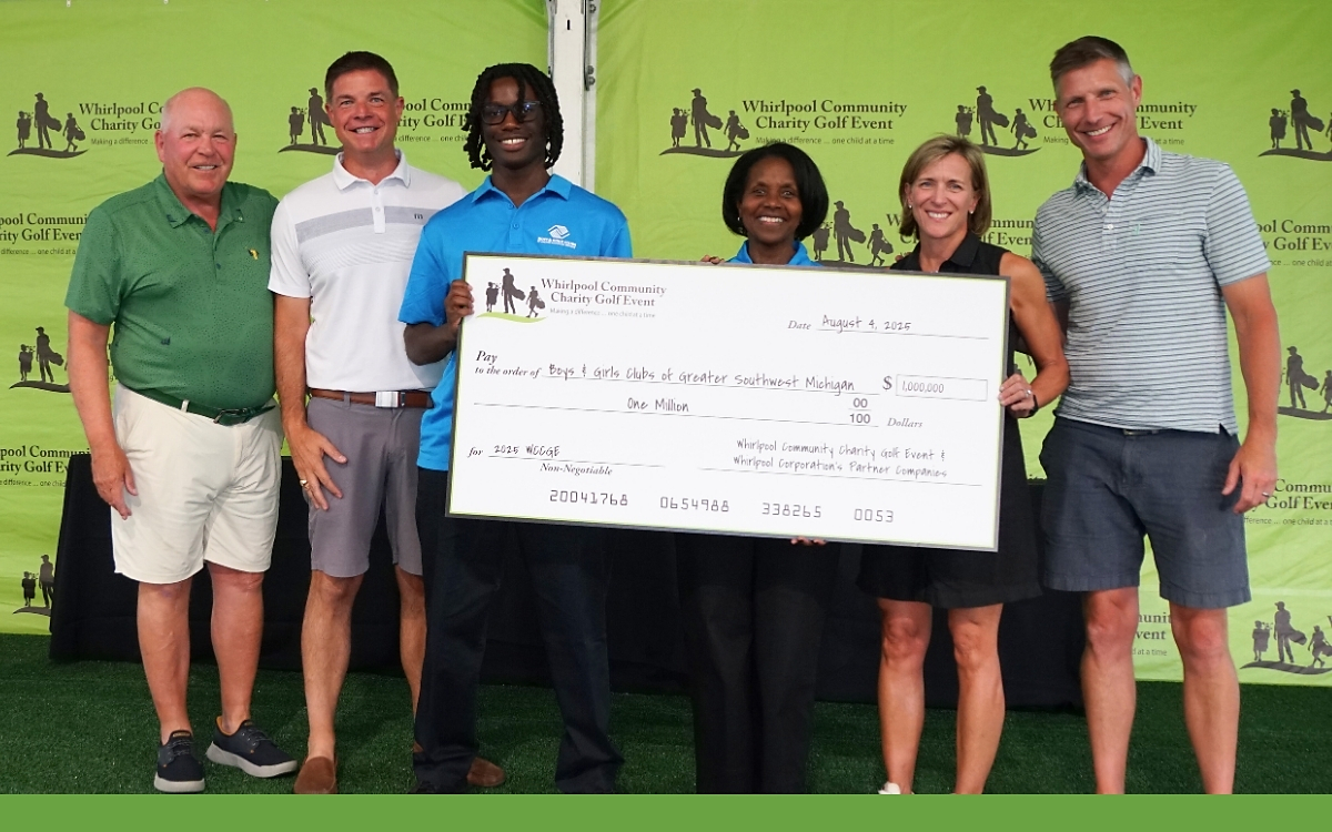 People posing with an oversized check