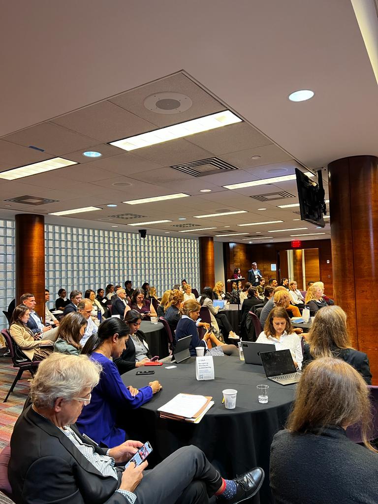 Tables of seated people in a conference room.