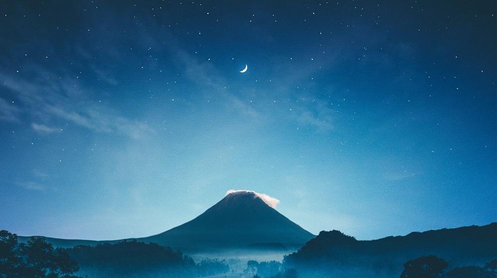 panoramic view of a large open night sky above a mountain