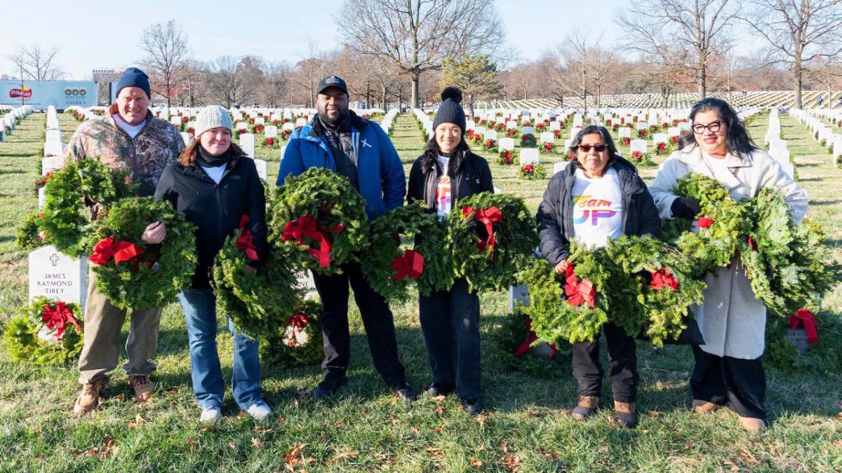 group standing with wreaths 