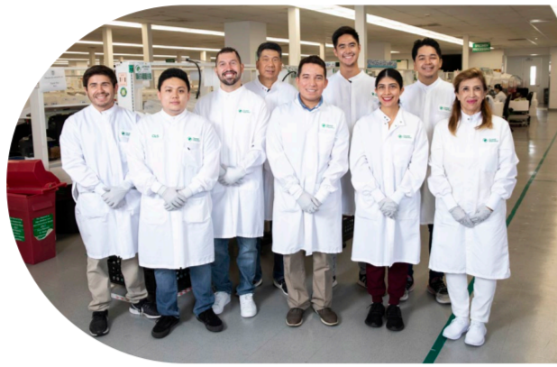 A group posed in protective lab gear.
