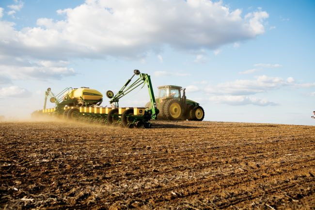 Tractor in field under blue sky