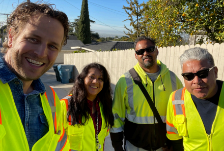 Group of four people in safety vests posed.