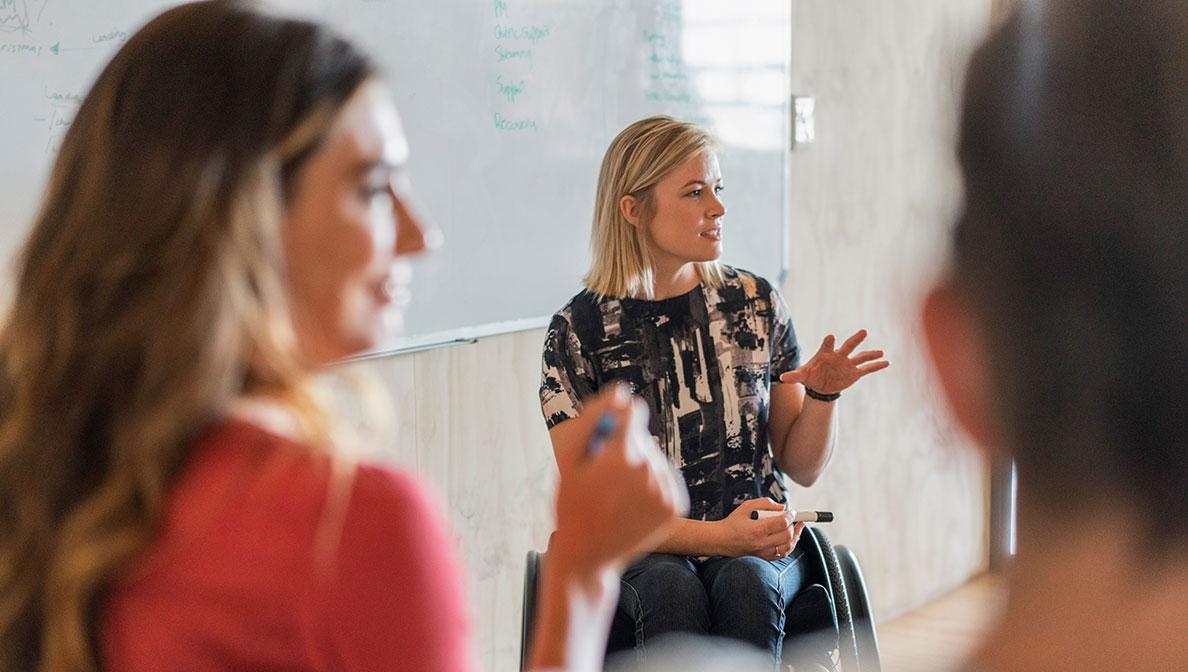 Woman in a wheelchair at a meeting