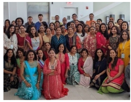 A group of people celebrating Diwali, posed for the camera.