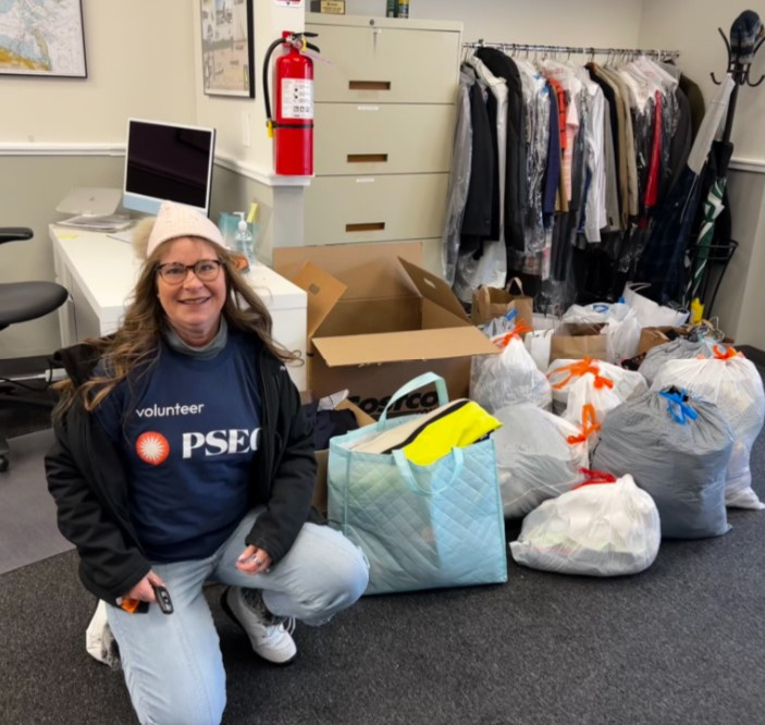 PSEG volunteer with bags of donated clothes