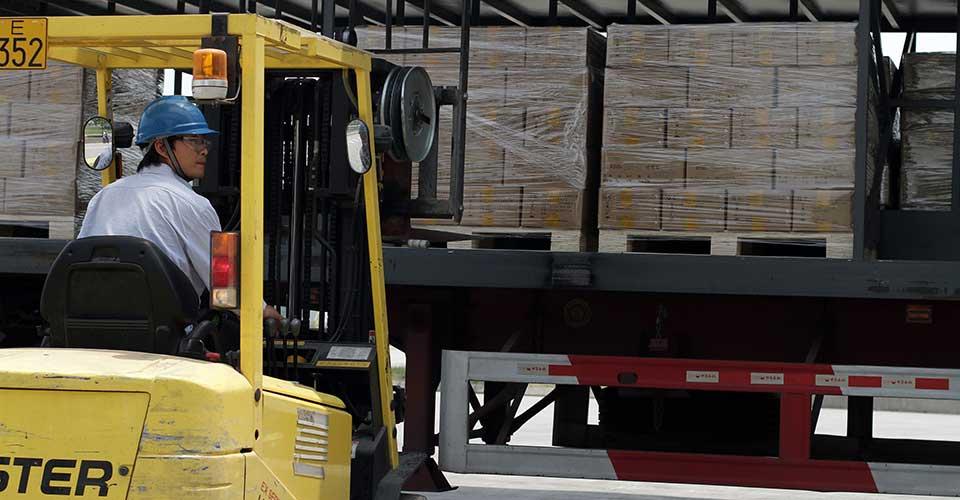 person driving a machine in a warehouse