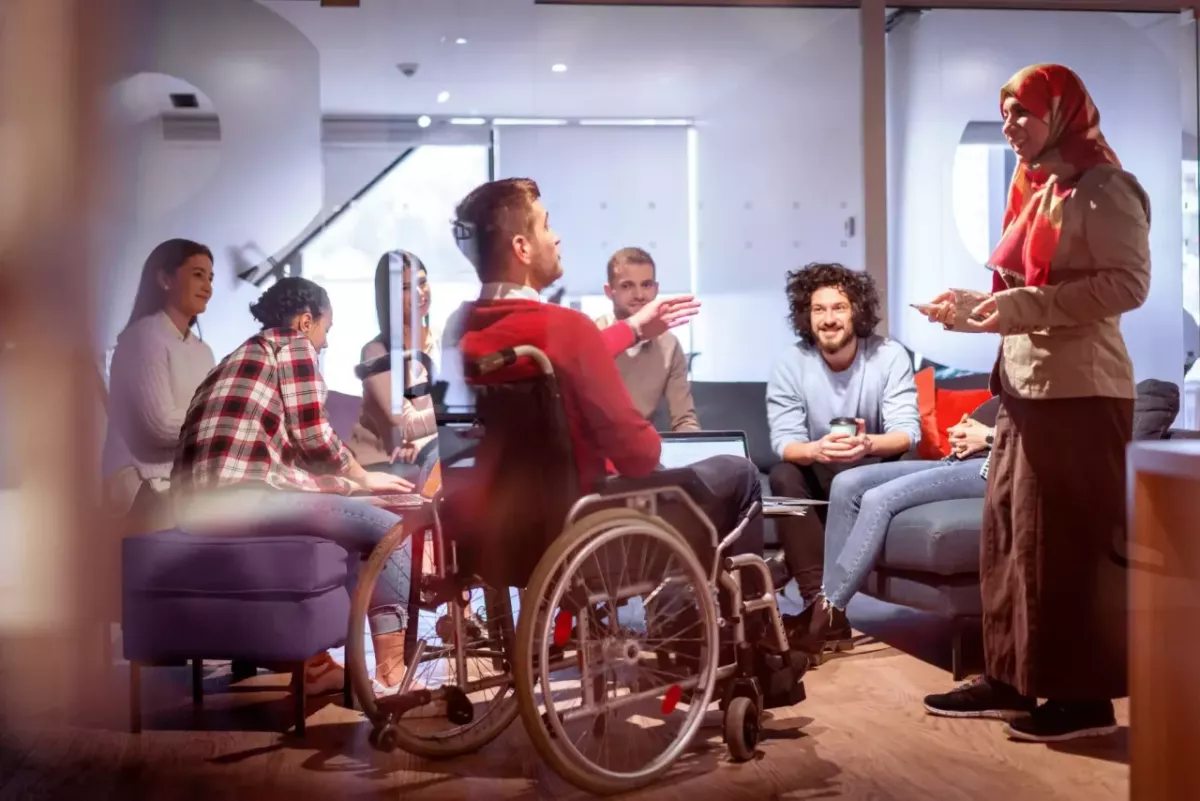 A diverse group of people meeting in a comfortable office setting.