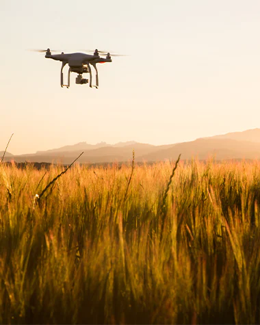 Drone flying over field