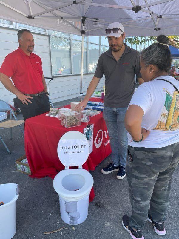 An employee showing attendees a display.