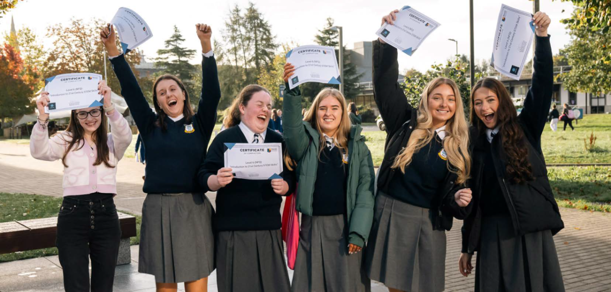 6 people raising diplomas and cheering